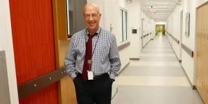 Dr. Gilman walking in Clinical Center E-Wing.