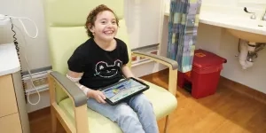 clinical center pediatric patient playing game on tablet